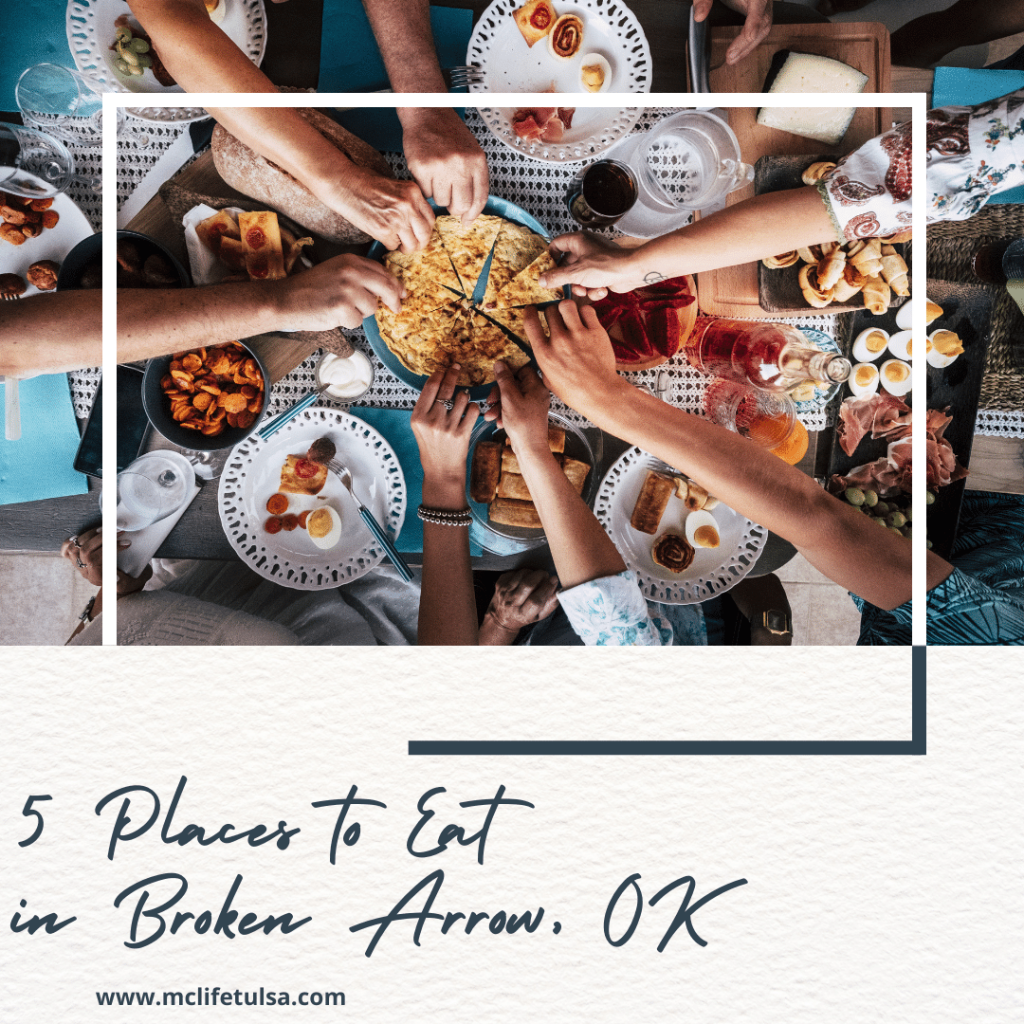 7 people grabbing for a slice of bread in the center of a table, restaurant vibe and full plates on the table