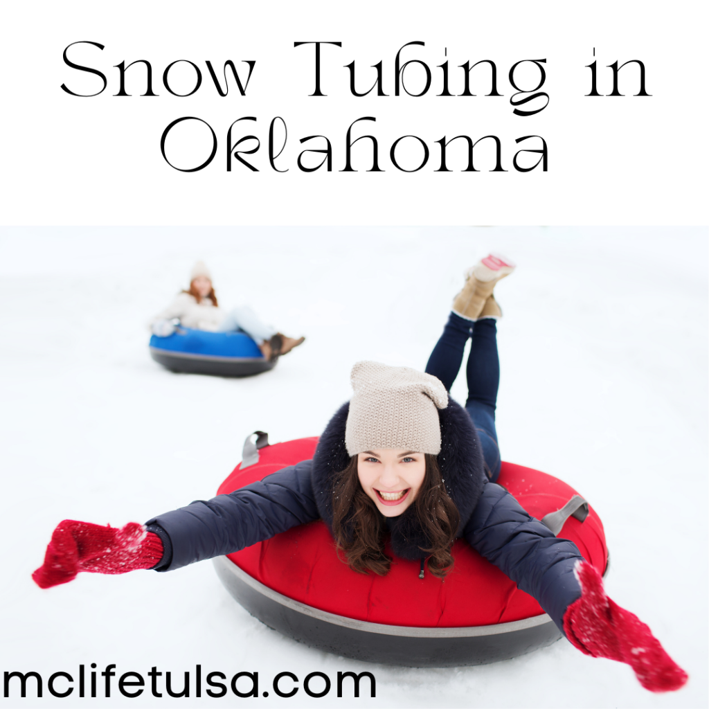 Image of woman wearing a black coat sledding down a snow hill on a red innertube. She is smiling and has her arms stretched out.