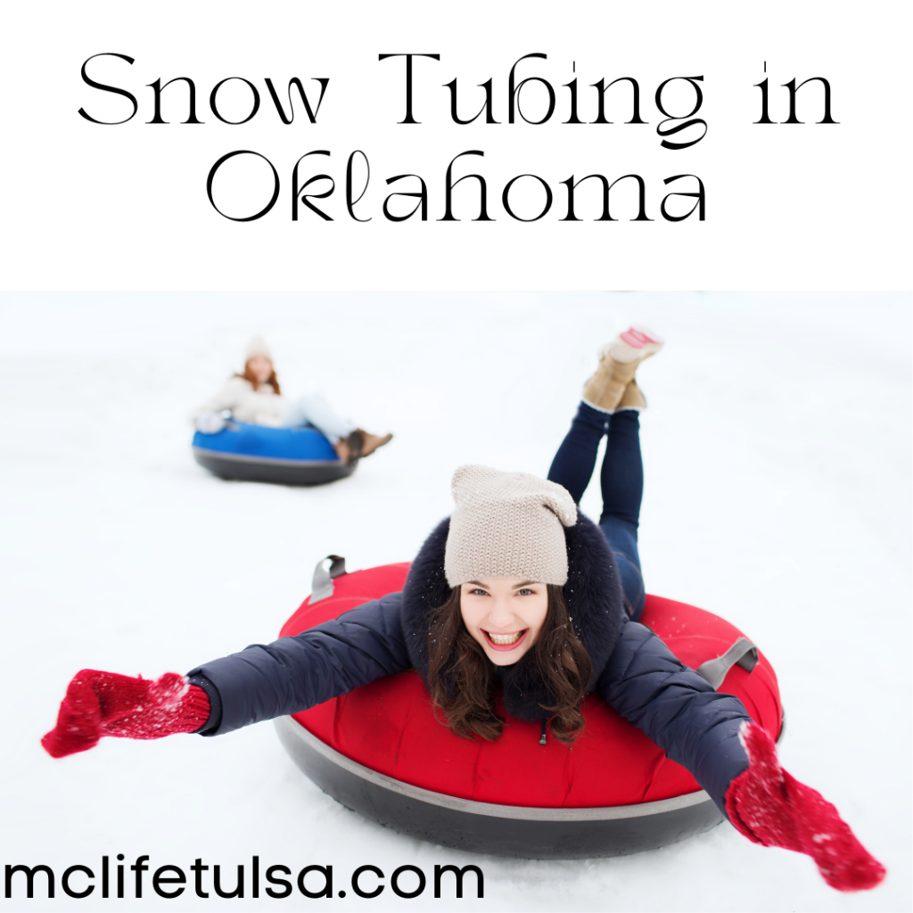 Image of woman wearing a black coat sledding down a snow hill on a red innertube. She is smiling and has her arms stretched out.  