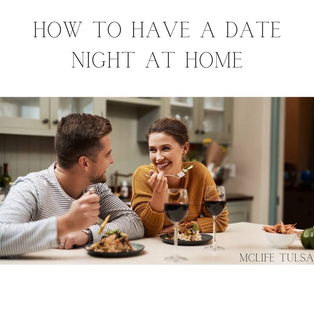 Image of man and woman eating dinner with a glass of wine at home on a date.