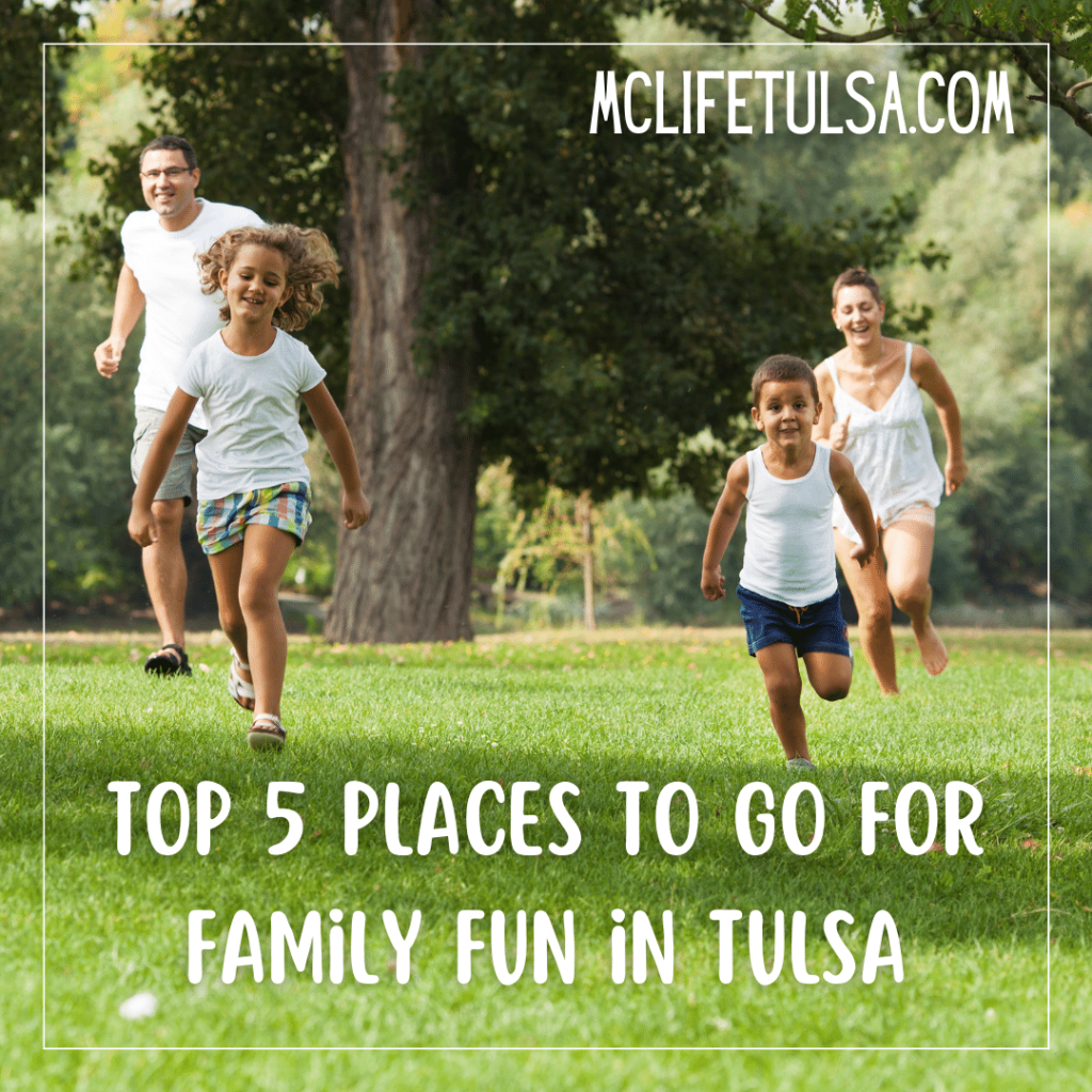 Image of family running through the green grass at a local park.  