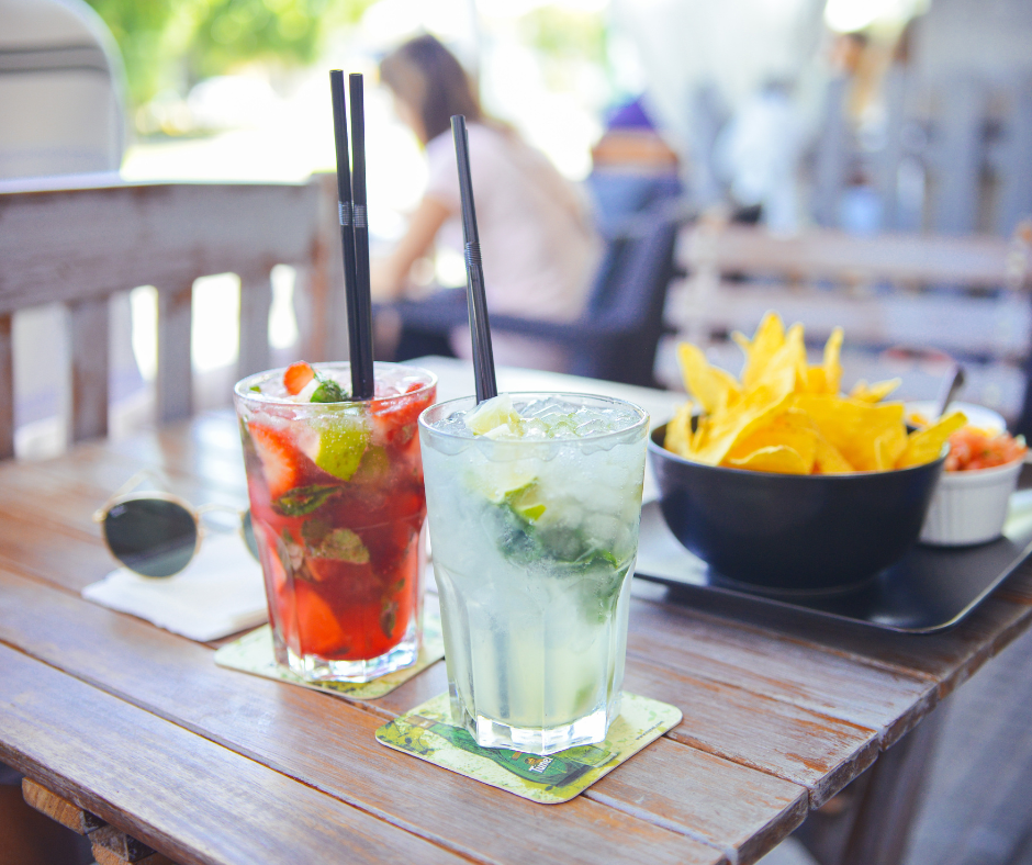 beverages chips and salsa on a table in a restaurant